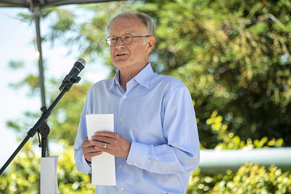 Person wearing blue shirt in front of microphone