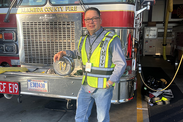 man standing in front of a fire truck
