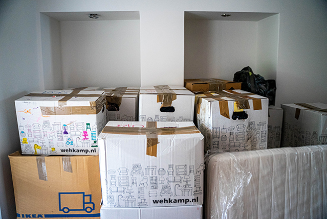 Moving boxes in a dorm room