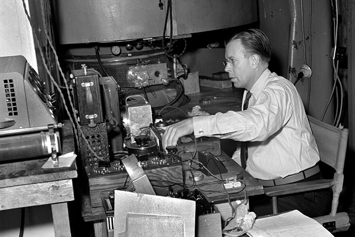 Ernest Lawrence sitting at cyclotron 1941