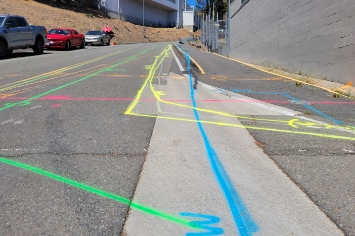 photo of roadway with multiple colored lines drawn across it in several directions