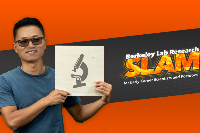 Researcher Gan Chen holds an illustration of a microscope in front of the Berkeley Lab Research SLAM logo