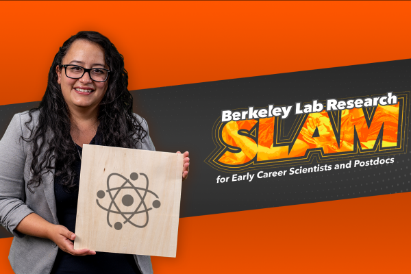 Researcher Fatima Garcia holds an illustration of a molecule in front of the Berkeley Lab Research SLAM logo