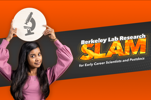 Researcher Sabari Ghosh holds an illustration of a microscope in front of the Berkeley Lab Research SLAM logo