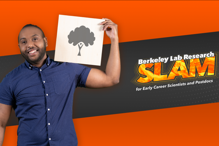 Researcher Mohammed Ombadi holds an illustration of a tree in front of the Berkeley Lab Research SLAM logo