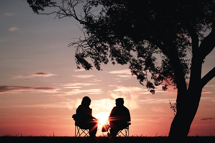 photo of two people at sunset