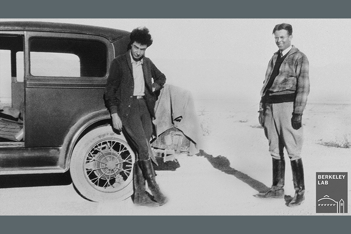 historical photo of physicists J. Robert Oppenheimer and E. O. Lawrence outside next to automobile