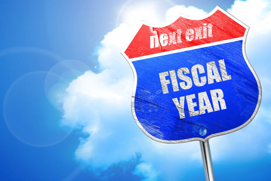 highway road sign reading "next exit: fiscal year"