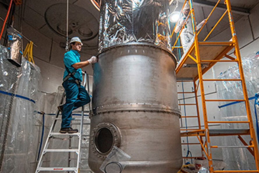 Engineers Charles Maupin and Jake Davis work to install one of the LUX-ZEPLIN (LZ) chambers.