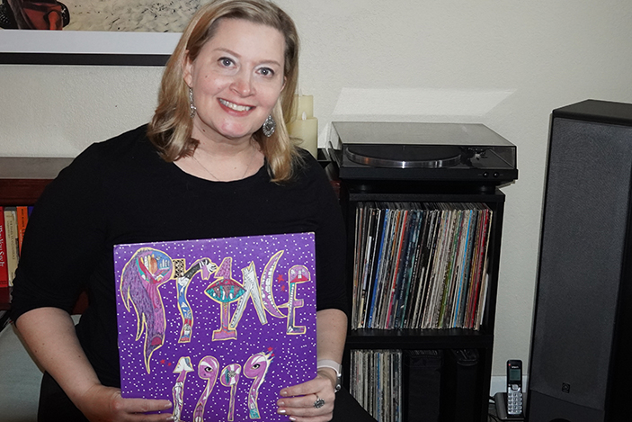 woman holding purple record album cover