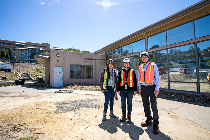 Lab Director Mike Witherell stands with PIM Project Director Lisa Ehlers and PIM Construction Manager Lindsay Nakaki in front of the soon-to-be-demolished building 54