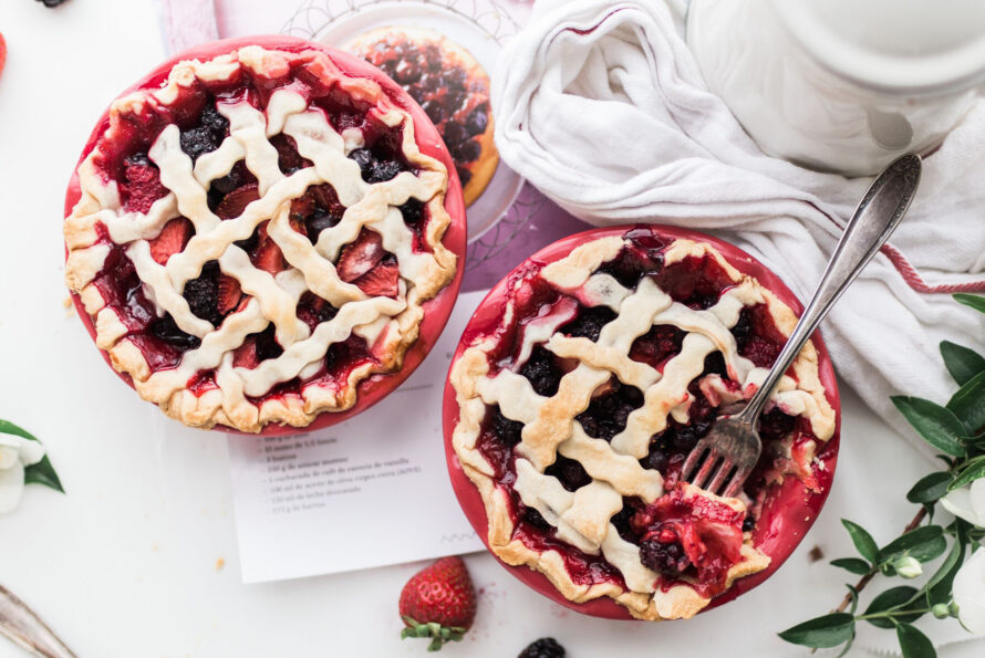 two strawberry pies on table