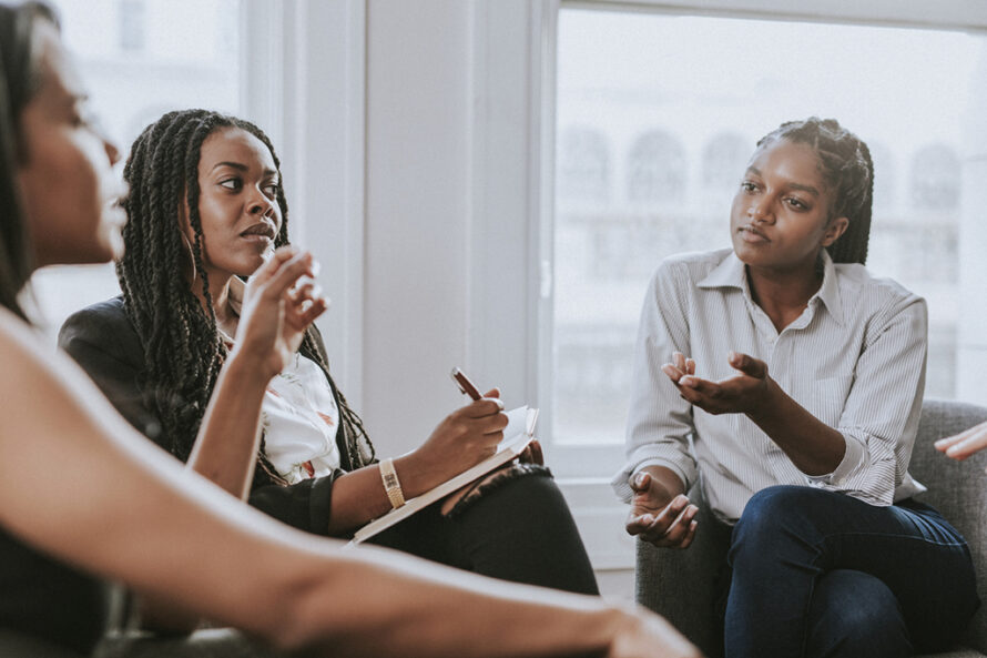 Three professional persons in discussion