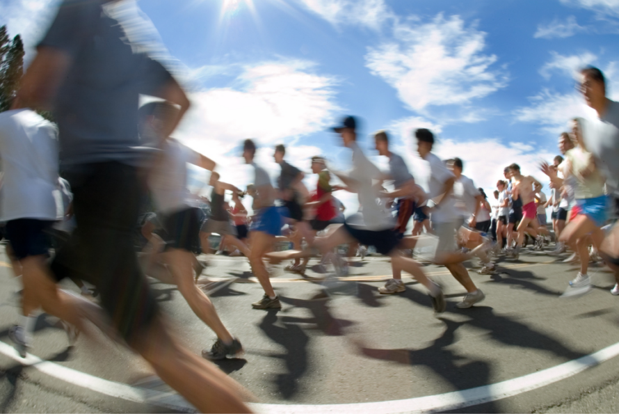 out of focus image of a group of runners passing in front of the camera