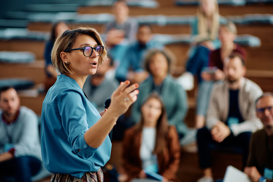 Person lecturing to a large audience