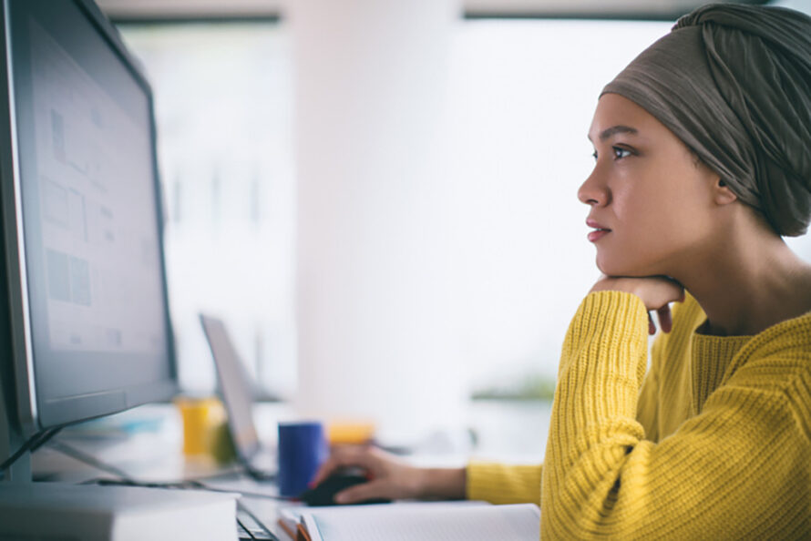 Person sitting with desktop computer looking at screen