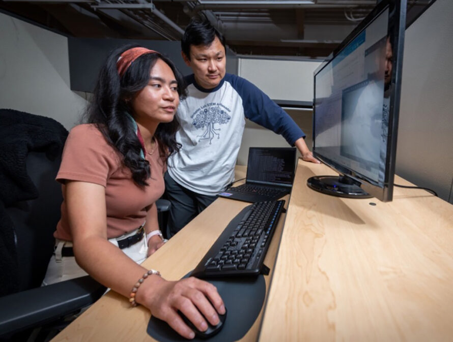 Two people looking at computer screen