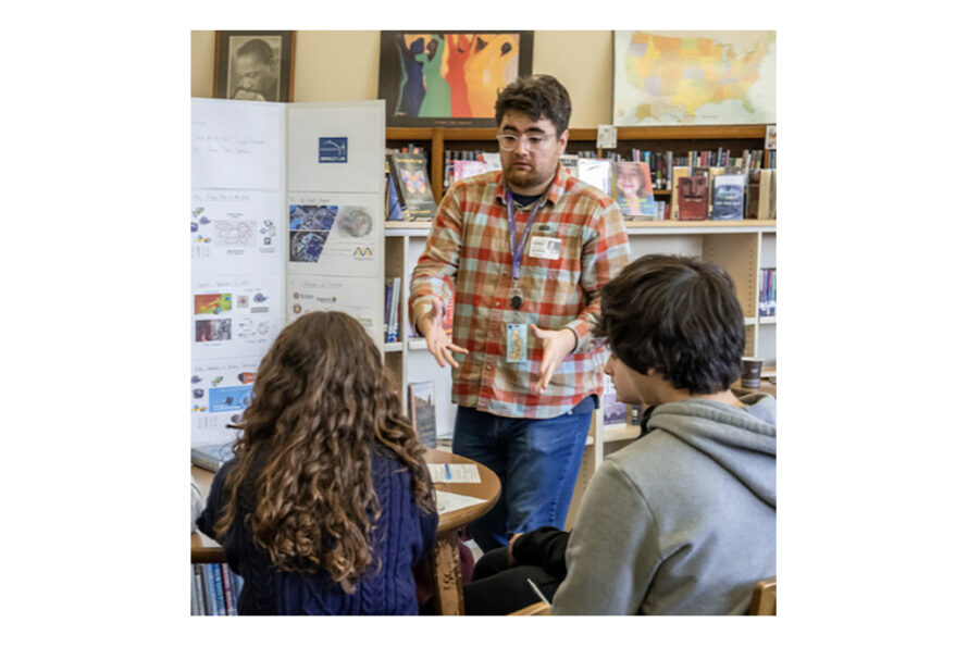 Adult talking to class of students