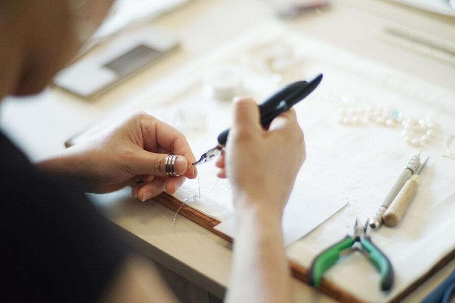 Person working with small tools to repair jewelry