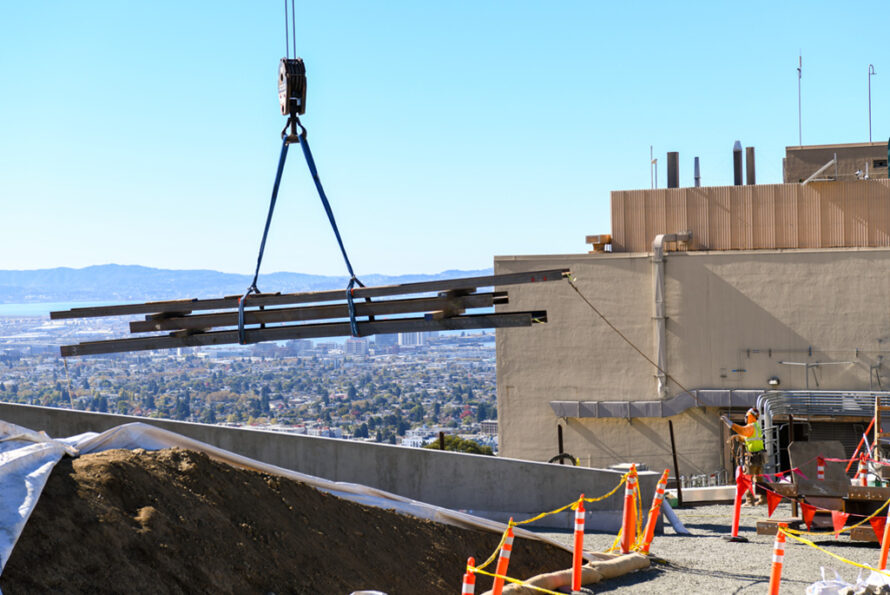 Beams lifted onto a construction site.