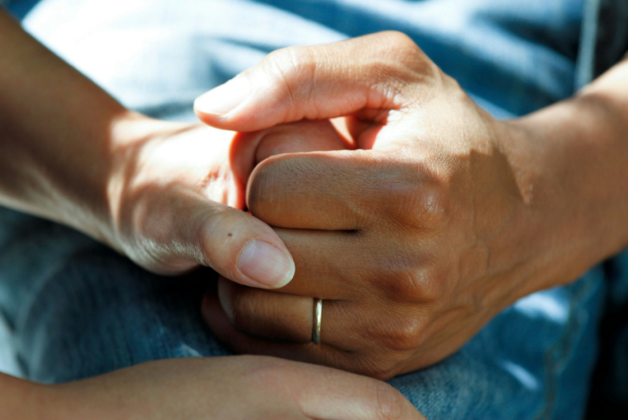 closeup of two people holding hands