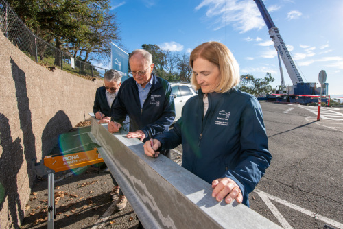 Lab Director Mike Witherell, Deputy Lab Director for Research Carol Burns, and Deputy Director for Operations Michael Brandt sign the Collaboration Commons structural steel beam