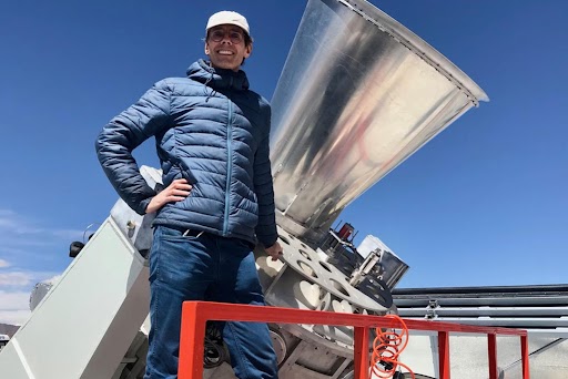 Person standing beside physical science equipment