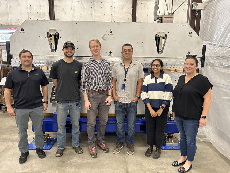 Berkeley Lab researchers pose with components developed for the SLAC Linac Coherent Light Source high-energy upgrade project