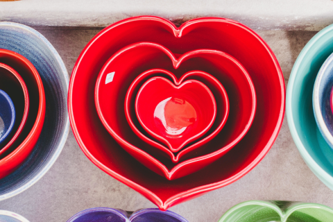 Photo of collection of red heart-shaped bowls nested within each other