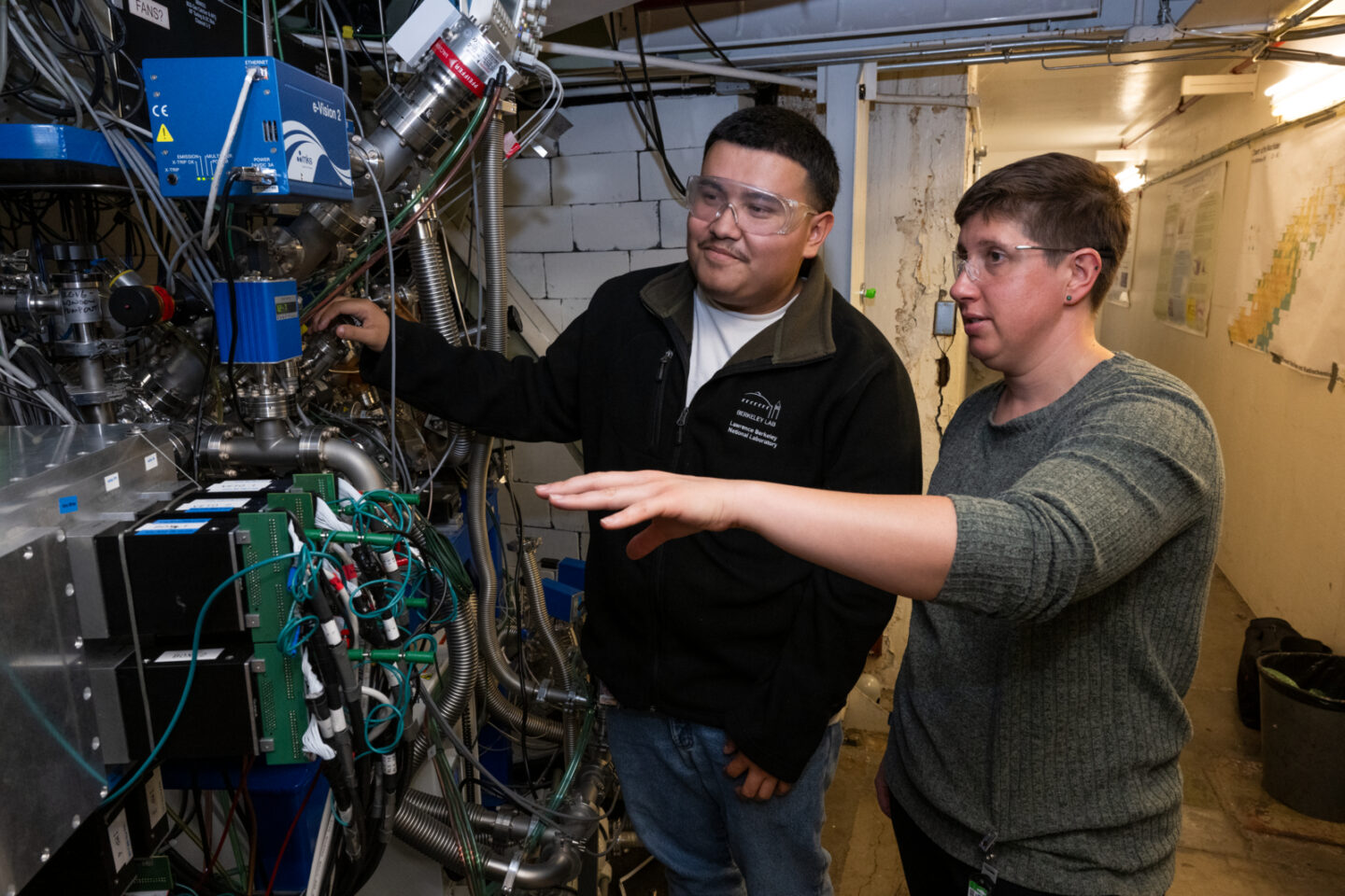 Photo of two persons in science laboratory examining equipment