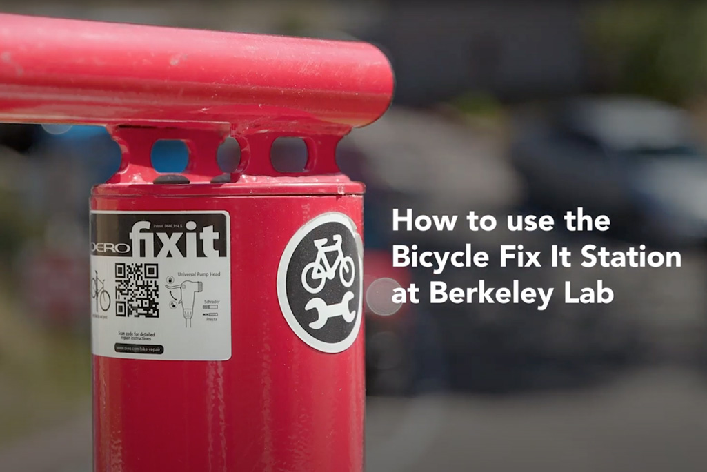 Close up of red bicycle fix it tool. Text on the right reads, "How to use the Bicycle Fix It Station at Berkeley Lab."