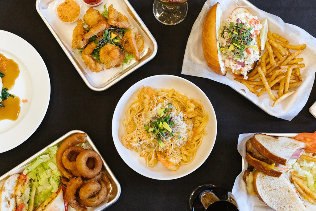 Selection of food dishes photographed against black background