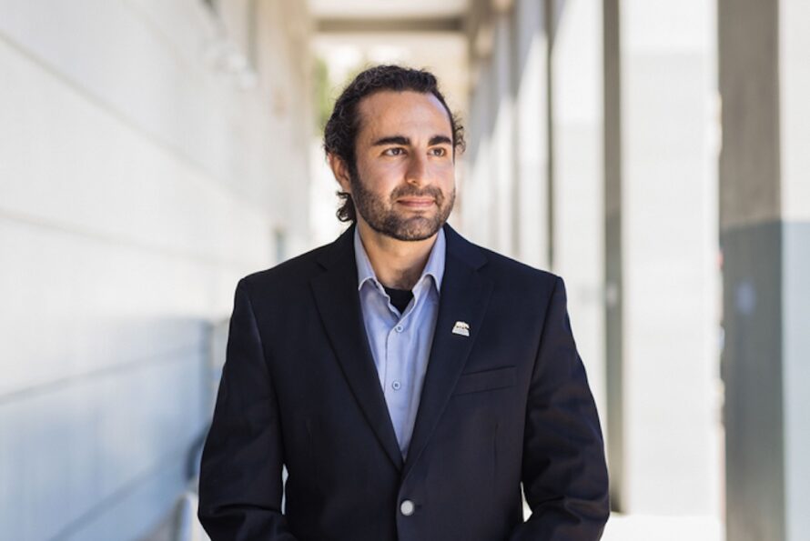 Headshot of person wearing dark blue blazer.