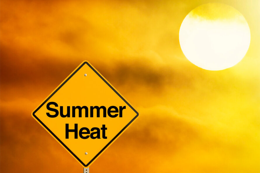 A yellow road sign reads "Summer Heat" against a bright, hazy sky with the sun shining in the background.