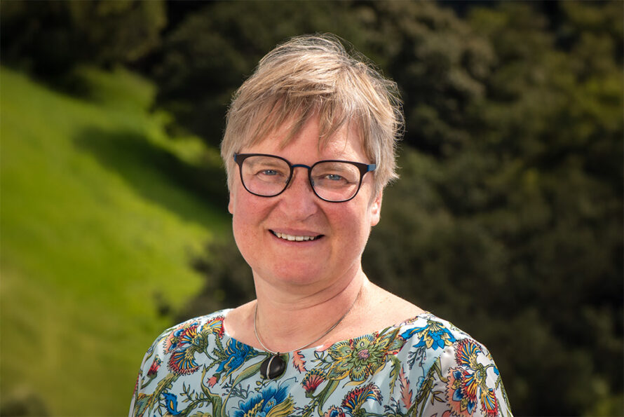 Person wearing glasses standing in outdoor setting
