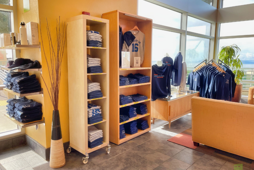 Image of t-shirts and other merchandise displayed in a shop