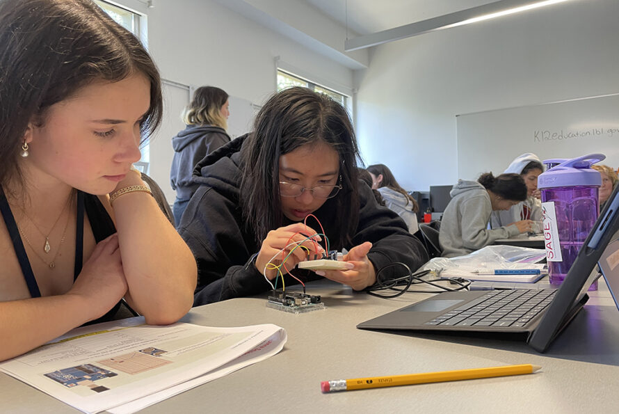 Two young people working on circuit
