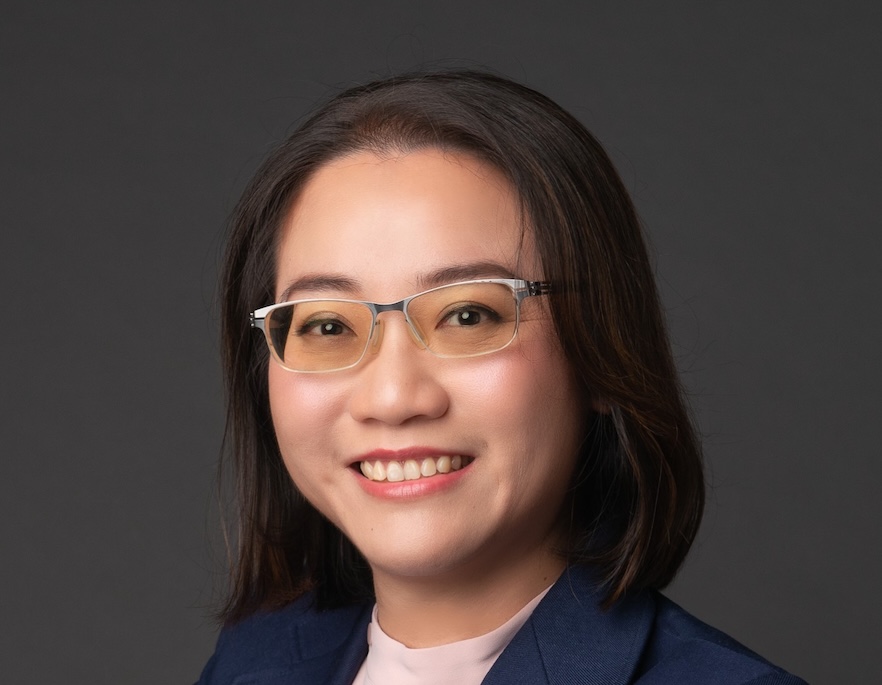 Headshot of person with long black hair wearing glasses.