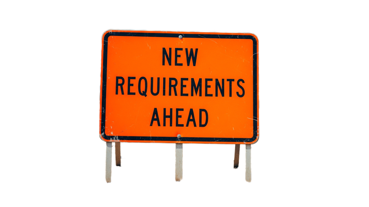 Orange road hazard sign reading "New Requirements Ahead".