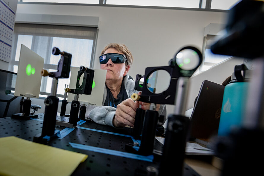 Person wearing laser glasses working with laser