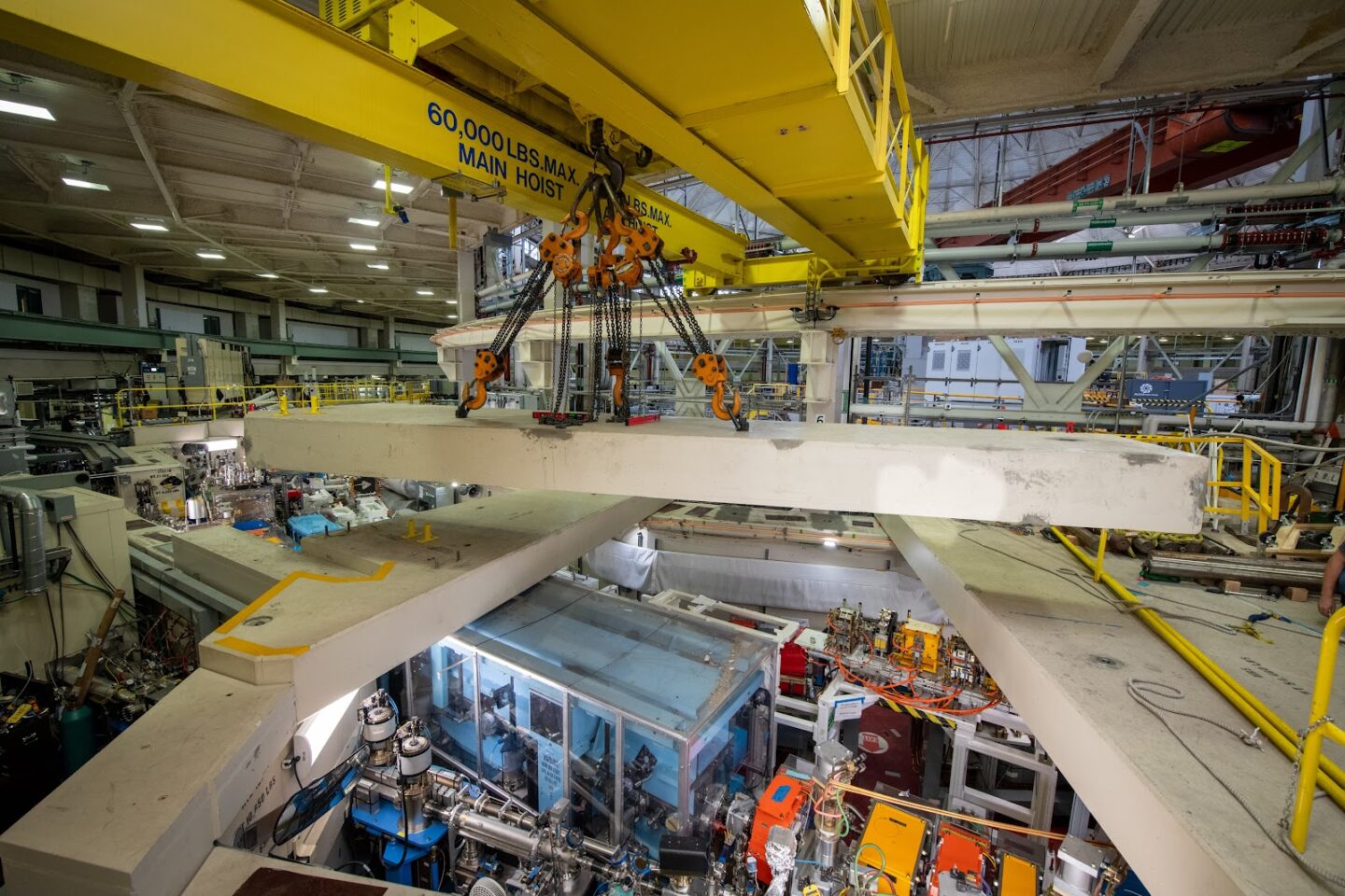 Heavy rigging equipment moving large concrete roof blocks.