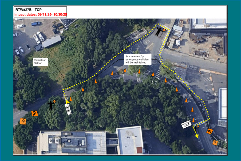 Aerial view of a roundabout at the Lab with markings and text indicating retaining wall construction work and pedestrian detours.