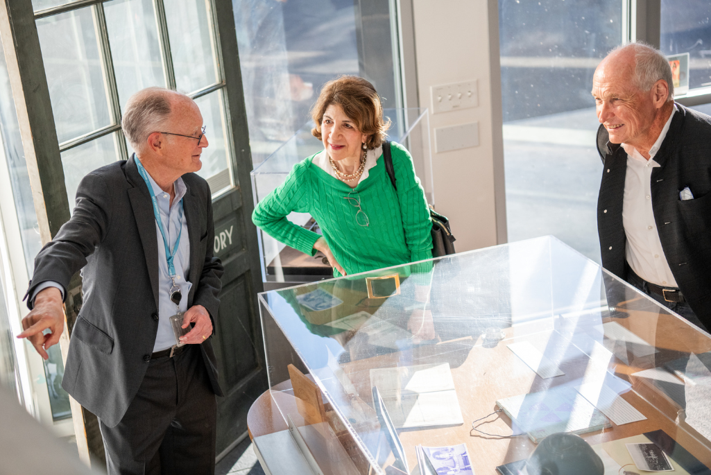 Laboratory Director Mike Witherell shows CERN Director-General Fabiola Gianotti and EPP Co-Chair Michael Turner historic photos in B50 lobby