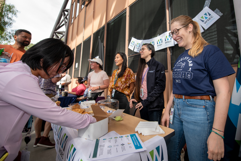 group shot of several people at an event booth talking
