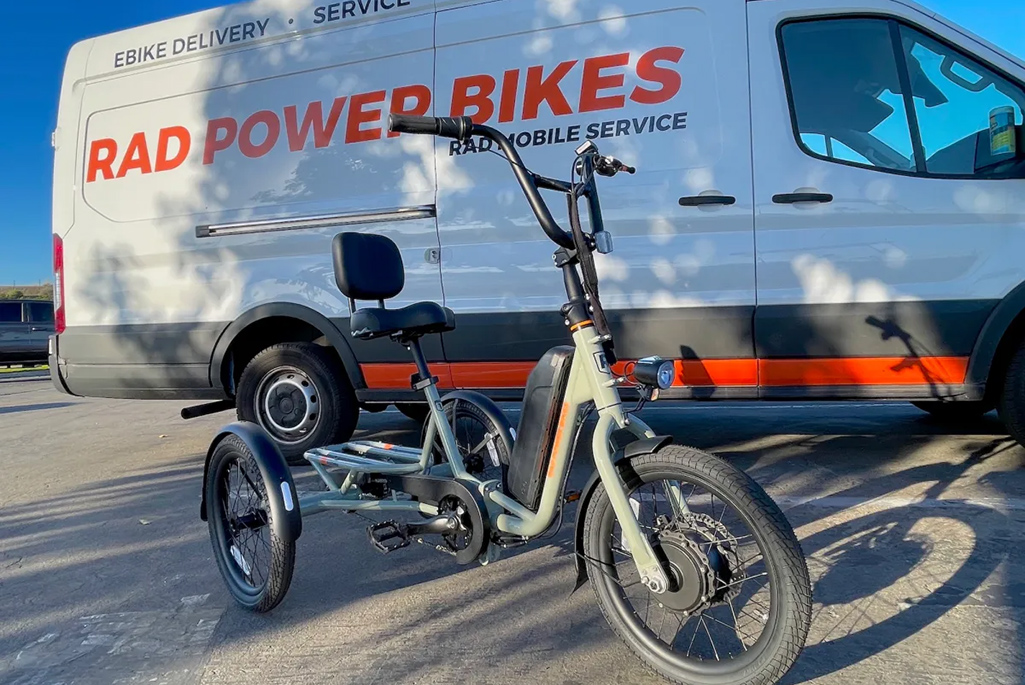 E power bike in front of white van