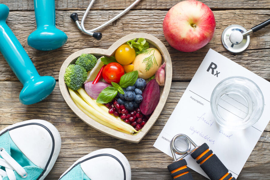 Fresh produce, shoes, fitness equipment, and a medical prescription against a wooden plank background.