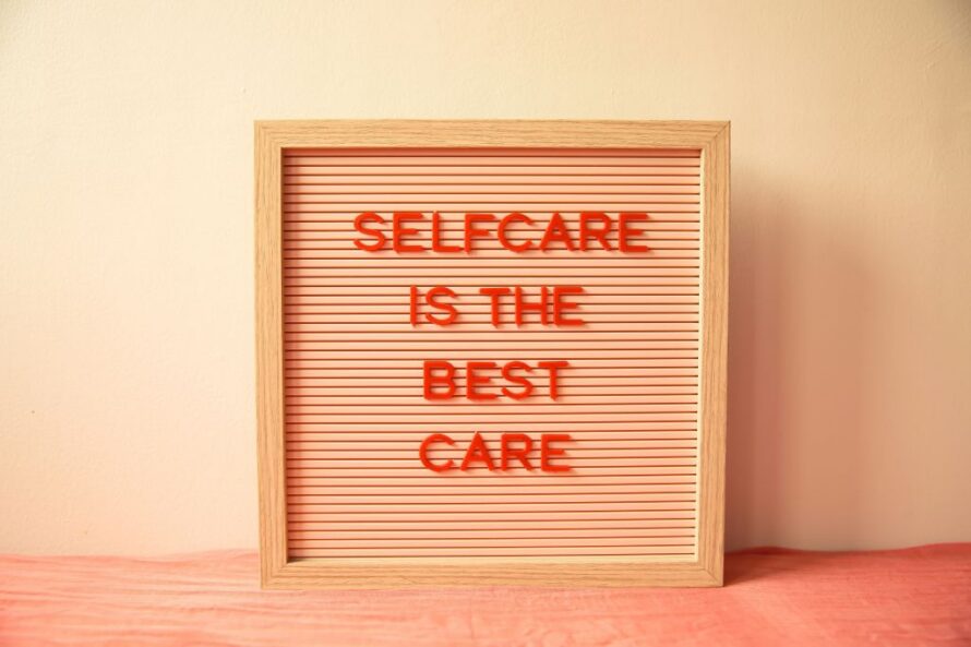 Wooden-framed plaque with red words "Selfcare is the Best Care"