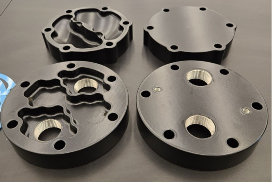 Four black discs with threaded screw holes that are part of server room chiller at Berkeley lab