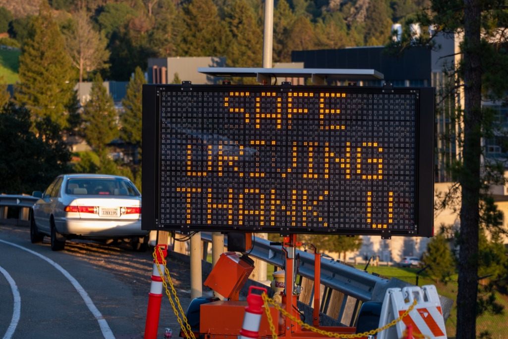 Orange construction sign on the Lab hillsite campus reads, Safe Driving Thank U