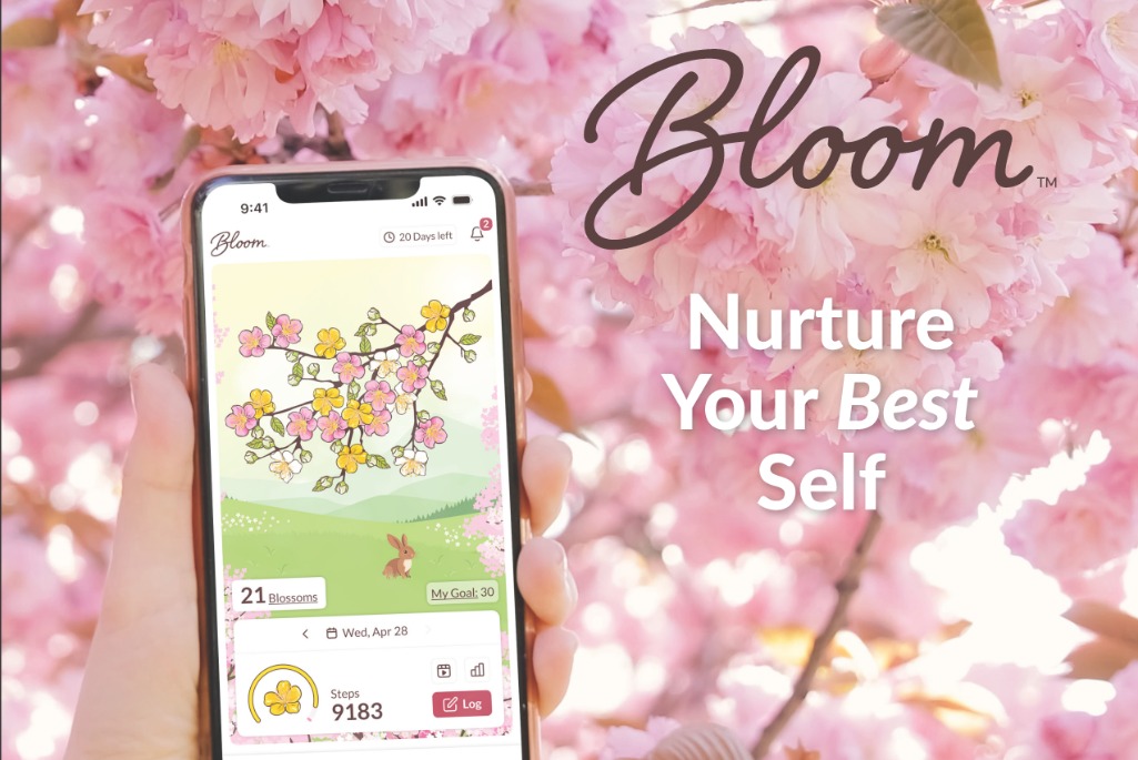 Hand holding a phone with a movement tracking app against a background of pink cherry blossoms. The text reads, “Bloom. Nurture Your Best Self.”